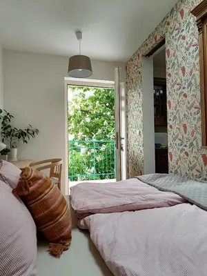 a bedroom with two twin beds and a window at Yesblisko in Kraków