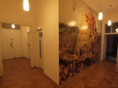 a large painting on the wall of a room at Wieża Babel in Kraków