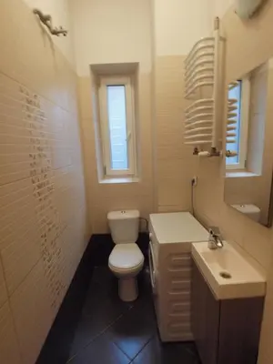 a bathroom with a toilet and a sink and a mirror at Wieża Babel in Kraków