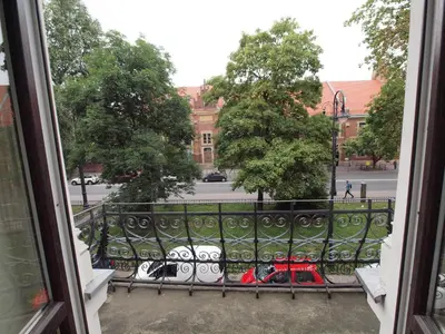a view from a window of a street with parked motorcycles at Wieża Babel in Kraków