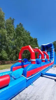 a blue and red water slide in a park at Hotel Karpik Zator Graboszyce in Graboszyce