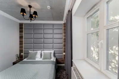 a bedroom with two beds and a window at Main Station Stay in Kraków