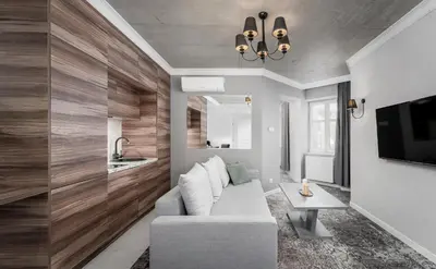 a living room with a couch and a tv at Main Station Stay in Kraków