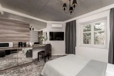 a bedroom with a bed and a desk with a computer at Main Station Stay in Kraków