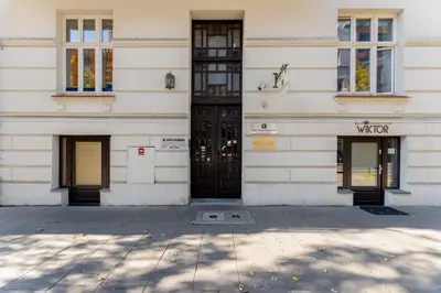 a building with two sets of doors on it at Main Station Stay in Kraków
