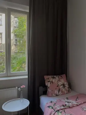 a small room with a bed and a window at Cozy Rooms Old Town in Kraków