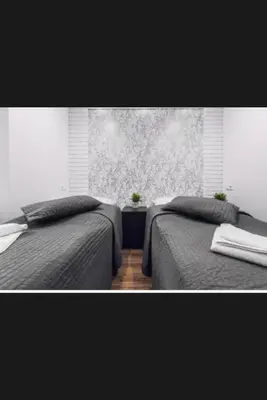 two beds sitting next to each other in a bedroom at Beer Street Apartment in Kraków
