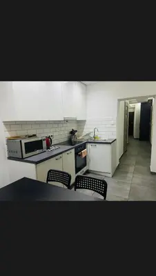 a kitchen with two chairs and a counter top at Beer Street Apartment in Kraków
