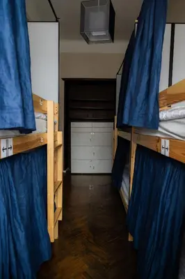 a room with a door with a sign that reads reception at FiveHostel in Kraków
