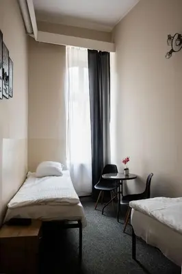a room with a table and two chairs and a table at FiveHostel in Kraków