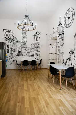 a kitchen with a drawing on the wall at FiveHostel in Kraków