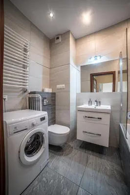 a bathroom with a washing machine and a toilet at Jop in Kraków