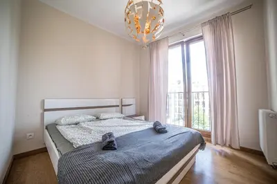a bedroom with a bed with shoes on it at Jop in Kraków
