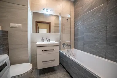 a bathroom with a toilet and a sink and a tub at Jop in Kraków