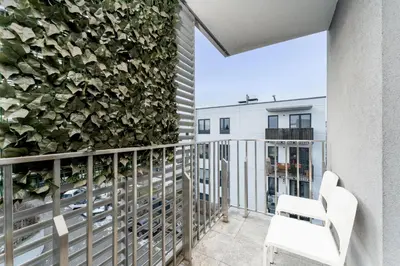 a row of three doors with a potted plant in the middle at Skowronia Modern Apartment by BookingHost in Kraków