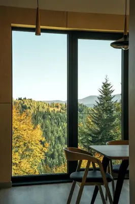 a table and two chairs in front of a window at Gontowe Zacisze in Zawoja