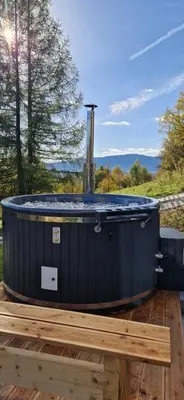 a blue hot tub sitting on a wooden deck at Gontowe Zacisze in Zawoja