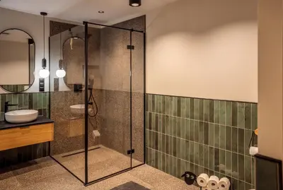 a bathroom with a glass shower and a sink at Gontowe Zacisze in Zawoja