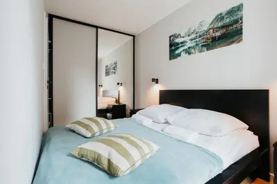 a bedroom with a large bed and a mirror at Domus Aurea Free Parking Garden Balcony in Kraków