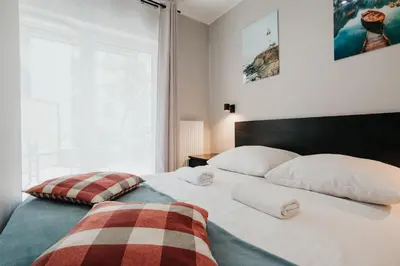 a bedroom with a bed with two pillows on it at Domus Aurea Free Parking Garden Balcony in Kraków