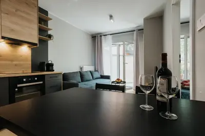two wine glasses sitting on a table in a kitchen at Domus Aurea Free Parking Garden Balcony in Kraków