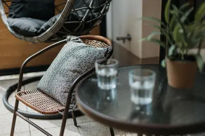 a table with a chair and two glasses of water at Domus Aurea Free Parking Garden Balcony in Kraków