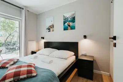 a bedroom with two beds and a window at Domus Aurea Free Parking Garden Balcony in Kraków