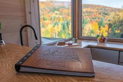 a book sitting on top of a wooden table at Zielone Wzgórze in Sidzina