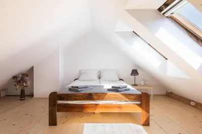 a bedroom with a bed in a attic at Charming Rustic Old Town Apartment in Kraków