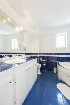 a bathroom with two sinks and a tub and a toilet at Charming Rustic Old Town Apartment in Kraków