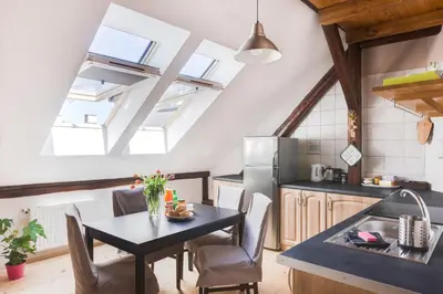 a kitchen with a table and a kitchen with skylights at Charming Rustic Old Town Apartment in Kraków