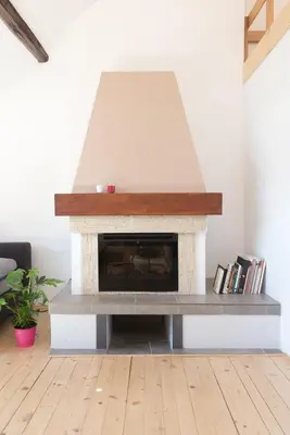 a fireplace in a living room with a stone at Charming Rustic Old Town Apartment in Kraków
