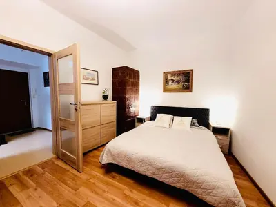 a bedroom with a bed and an open door at Castle Street in Kraków