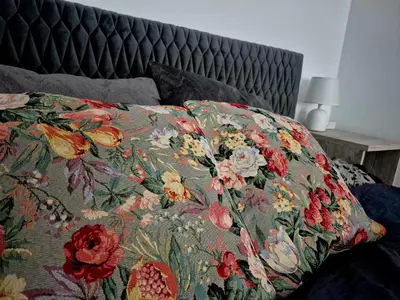 a pillow on a bed with a design on it at Castle Street in Kraków