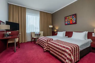 a hotel room with a bed and a desk at Premier Kraków Hotel in Kraków