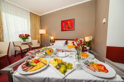 a hotel room with a table with food on it at Premier Kraków Hotel in Kraków