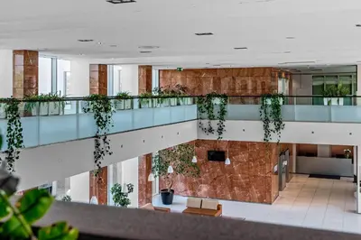 arium of a building with plants on the walls at Premier Kraków Hotel in Kraków