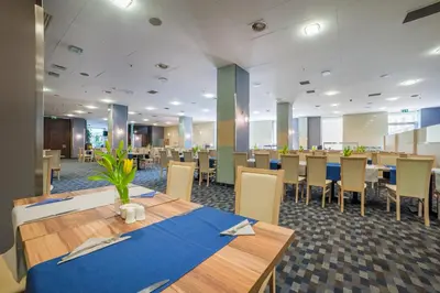 a dining room with a table and chairs at Premier Kraków Hotel in Kraków