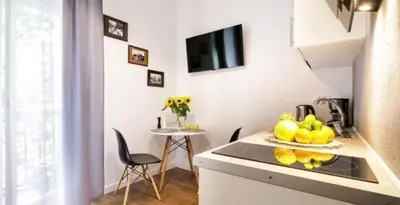 a kitchen with a sink and a table with chairs at Old Town Apt - Topolowa studio T33 in Kraków
