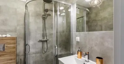 a bathroom with a shower with a sink and a shower at Old Town Apt - Topolowa studio T33 in Kraków
