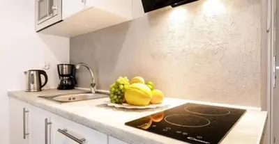 a kitchen with a sink and a counter with fruit on it at Old Town Apt - Topolowa studio T33 in Kraków