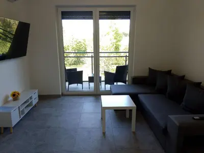 a living room with a couch and a table at Place Oswiecim - underground parking, air conditioning, Self Check In in Oświęcim