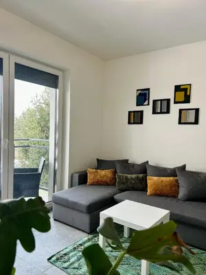 a living room with a couch and a table at Place Oswiecim - underground parking, air conditioning, Self Check In in Oświęcim