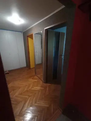 an empty room with a hallway with wooden floors at Apartament Humberta in Kraków