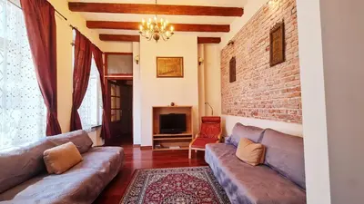 a living room with couches and a brick wall at Komfortowy Apartament na ul Brackiej 6B in Kraków