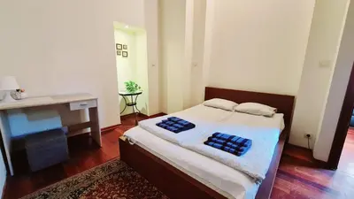 a bedroom with a bed with two pillows on it at Komfortowy Apartament na ul Brackiej 6B in Kraków