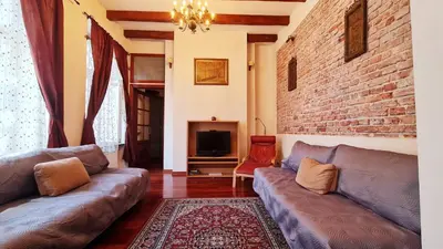a living room with two couches and a brick wall at Komfortowy Apartament na ul Brackiej 6B in Kraków