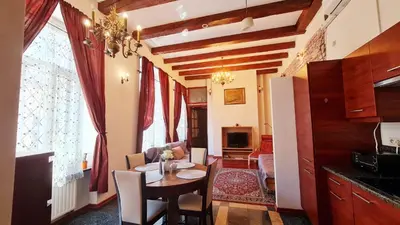 a kitchen and dining room with a table and chairs at Komfortowy Apartament na ul Brackiej 6B in Kraków