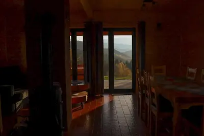 a room with a door open to a room with a view at Domki 15 szczytów in Zawoja