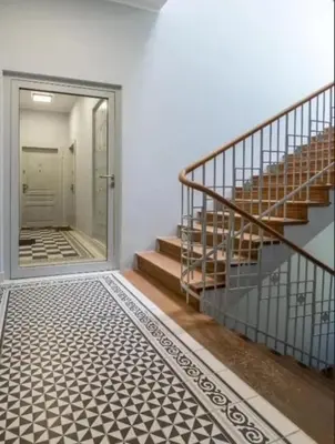 a hallway with a staircase and a glass door at Old Town Apt - Wielopole studio W6 in Kraków